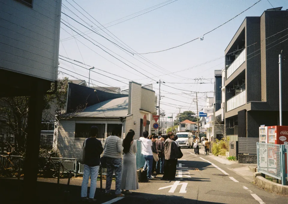 Customers waiting outside Pide on a sunny Omachi street